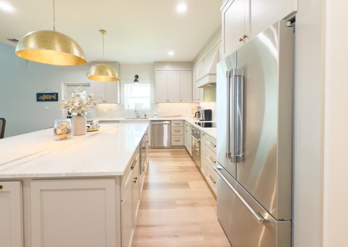 Kitchen with stainless appliances and gold fixtures