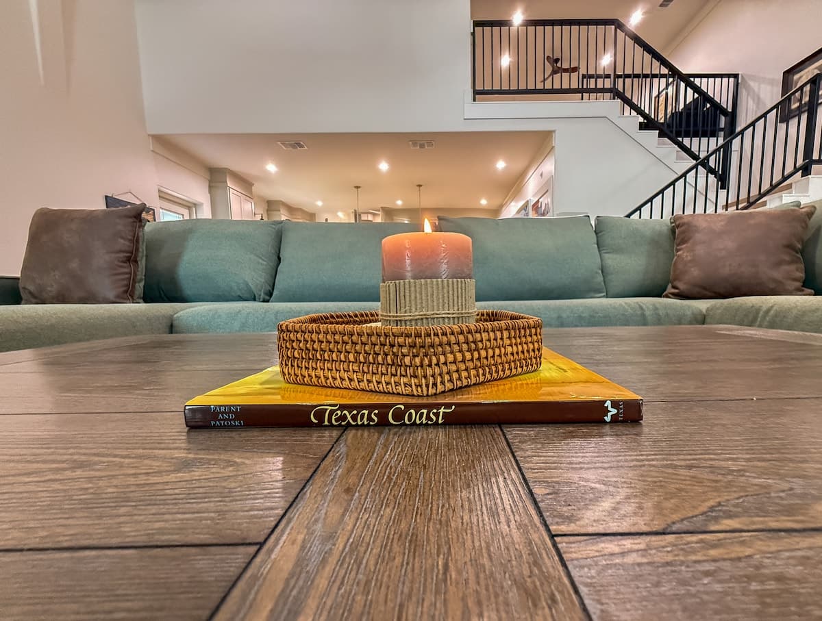 Texas Coast book and candle on coffee table