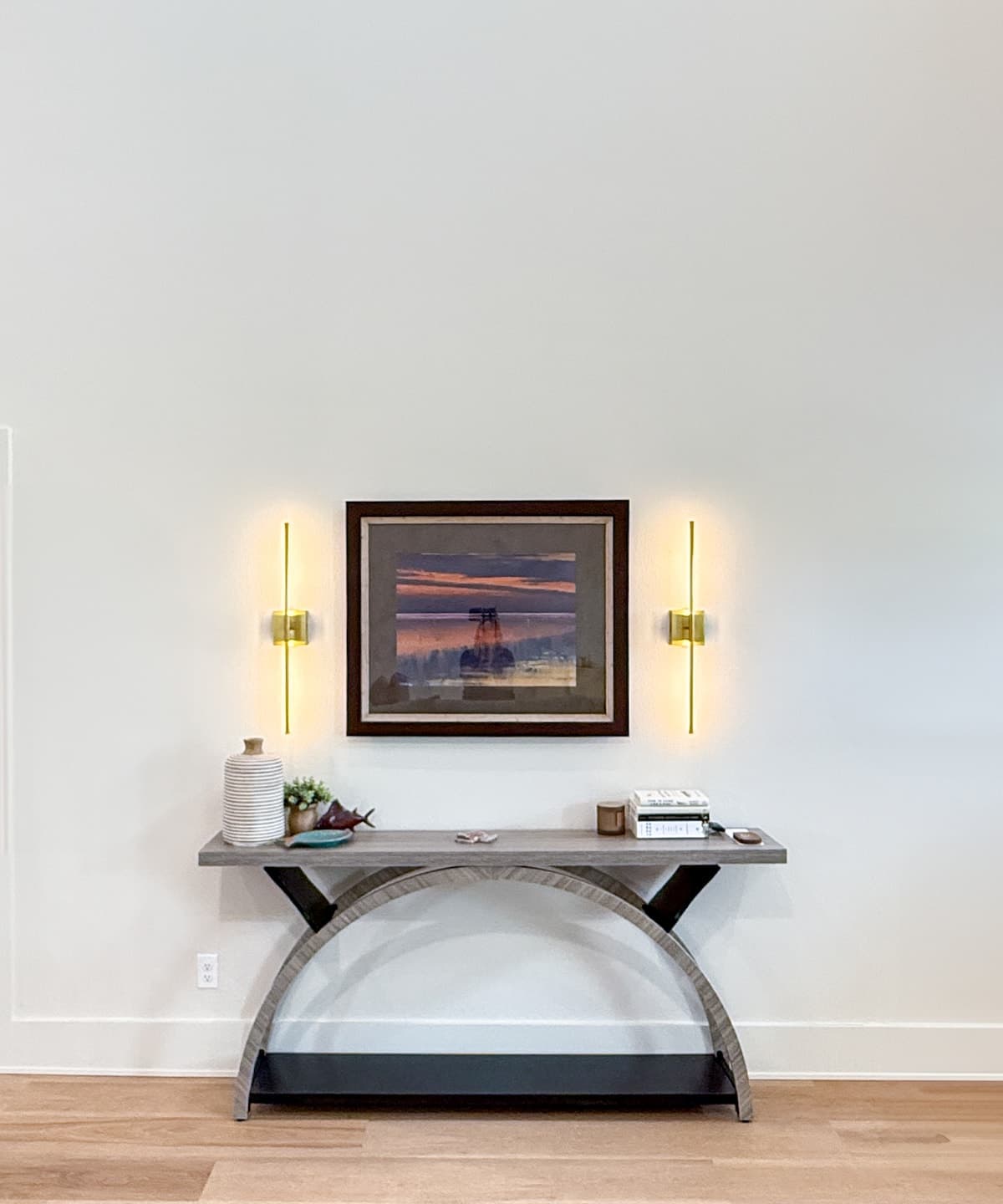 Sunset painting with brass sconces