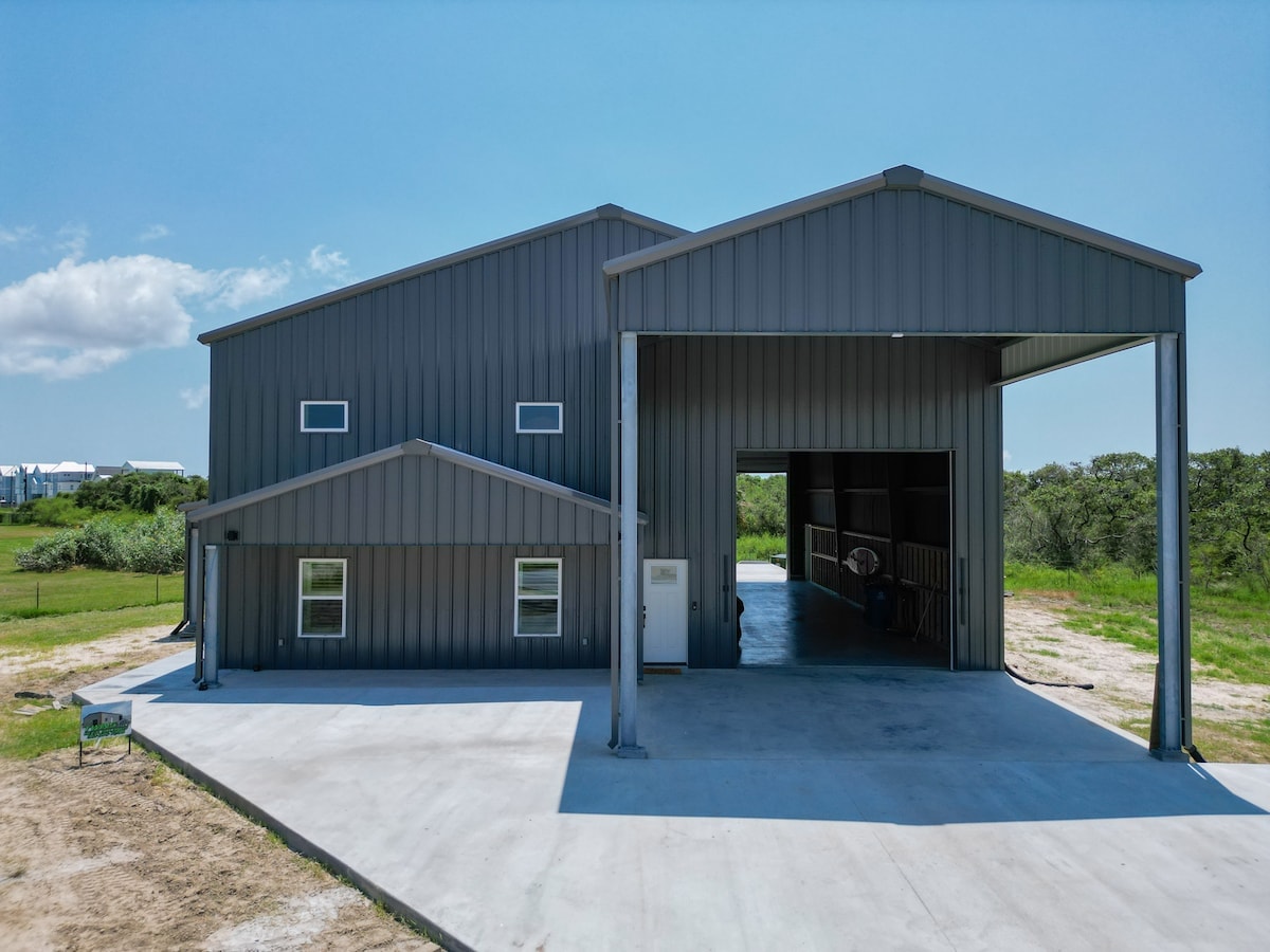 Moonlight Marsh exterior with the open 60-foot boat garage and paved driveway